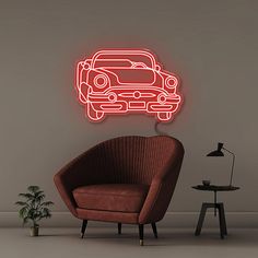 a red neon sign on the side of a wall next to a chair and potted plant