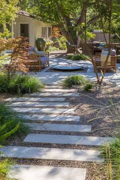 an outdoor patio with stone steps leading up to the house