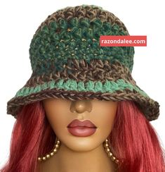 a mannequin head wearing a crocheted hat with red hair and earrings