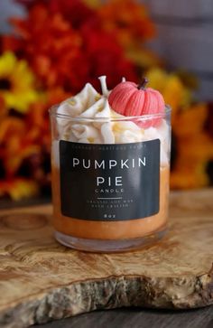 the pumpkin pie candle is sitting on a wooden table