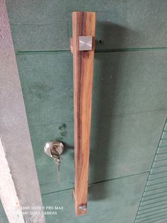 a wooden door handle with a key on it