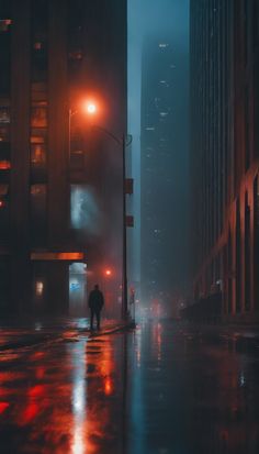 a person standing on a city street at night in the rain with an umbrella over their head