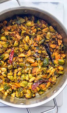 brussel sprouts and other vegetables in a pan on a stove top