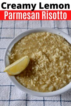 a white bowl filled with oatmeal next to a lemon wedge