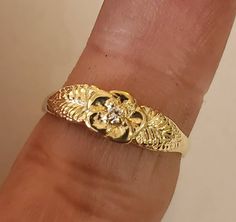 This is a beautiful 14KT yellow gold 5 pedal rose ring accented with a 3 pt si 1 gh color .03 pt diamond. Can be set with a different stone by request.This is one of my first carvings paying close attention to detail. Will always remain a classic. Comes in sizes 5 to 8. Allow 10 days handling time. Luxury Gold Flower Ring, Fine Jewelry Yellow Gold Flower Ring, Gold Flower-shaped Nature-inspired Rings, Gold Flower-shaped Pearl Ring For Wedding, Luxury Yellow Gold Flower-shaped Rings, Bell Gardens, Grunge Jewelry, Pretty Jewelry Necklaces, Handmade Gold Jewellery