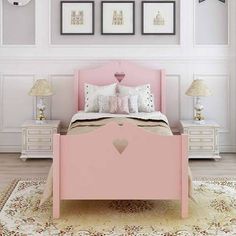 a pink bed in a white bedroom with pictures on the wall above it and two nightstands