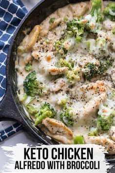 chicken alfredo with broccoli in a cast iron skillet on a blue and white towel