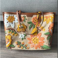 New With Tags, With Original Package. Get Vacay-Ready Style With This Woven Straw Tote Featuring Colorful Embroidered Flowers And A Roomy Interior. Size: 13.55" L X 11.16" H X 5.34" D Top Zip Closure Dual Shoulder Straps Exterior Features Woven Straw With Floral Embroidery And Leather Trim Lined Interior Textile And Leather Exterior/Cotton Lining Mannequin's Height For Scale: 5'9" Designer Embroidered Shopping Bag, Designer Embroidered Bags For Shopping, Designer Embroidered Tote Bag, Designer Embroidered Bags For Daily Use, Brown Bags With Embroidered Logo For Shopping, Tory Burch Perry Tote, Tory Burch Ella Tote, Orange Tote Bags, Plaid Tote Bag