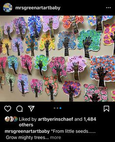 a bulletin board with lots of handprinted trees and butterflies on it's sides