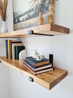 some books and vases are sitting on a shelf