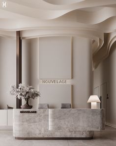 the front desk of an upscale hotel with flowers in vases and lamps on either side