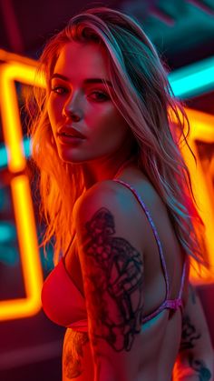 a woman with tattoos standing in front of neon lights