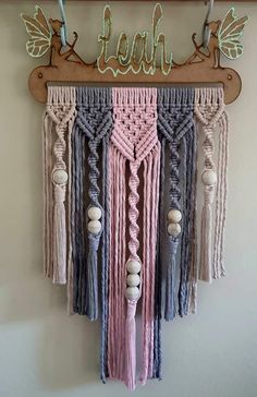 a wall hanging with some tassels on it