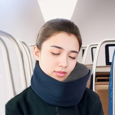 a woman with her eyes closed wearing a neck gaiter and looking down at the ground