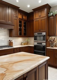 a kitchen with wooden cabinets and marble counter tops