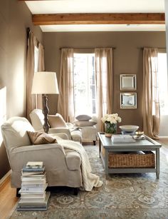 a living room filled with furniture and windows