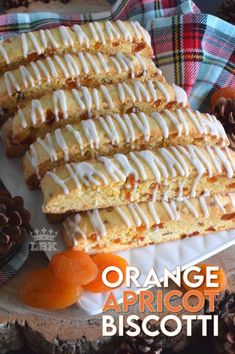 orange apricot biscotti on a white plate with pine cones in the background