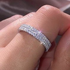 a woman's hand with a diamond ring on it