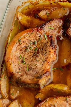 chicken and potatoes in a glass casserole dish with seasoning on top, ready to be eaten