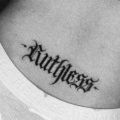 a black and white photo of a tattoo that reads,'faithless'on the chest