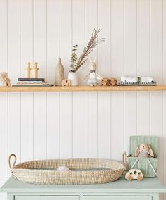 a baby's crib and toys on a shelf