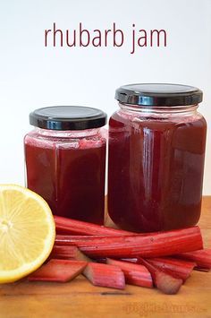 two jars filled with rhubarb jam next to sliced rhubaras