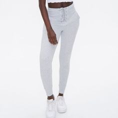 Forever 21 Lace Up Sweatpant Joggers High Rise M Heathered Lace-Up Joggers Color: Heather Grey From Forever 21 Size: Medium Details A Pair Of Heathered French Terry Joggers Featuring A Lace-Up Closure At The High-Rise Waist With High-Polish Aglets And Grommets, Front Slanted Pockets, And Ribbed Trim. Content + Care - 64% Cotton, 36% Polyester Trendy Forever 21 Bottoms With Elastic Waistband, Forever 21 Spring Loungewear Bottoms, Spring Loungewear Bottoms By Forever 21, Forever 21 Sporty Bottoms For Spring, Sporty Spring Bottoms From Forever 21, Forever 21 Cotton Loungewear Bottoms, Fitted High Waist Cotton Joggers, Fitted High-waist Cotton Joggers, Forever 21 Fitted Bottoms With Elastic Waistband