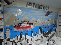 penguins and penguins are standing in front of a wall with an arctic scene on it