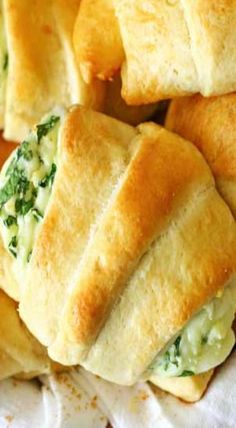 several rolls with spinach and cheese on them