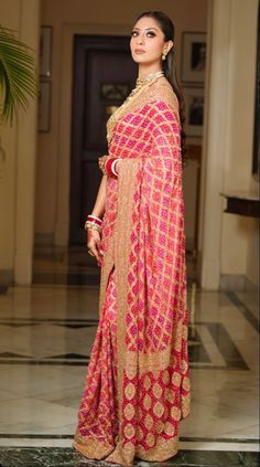 a woman in a red and gold sari