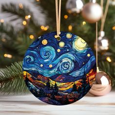 a christmas ornament with the starr night painting on it and ornaments around it