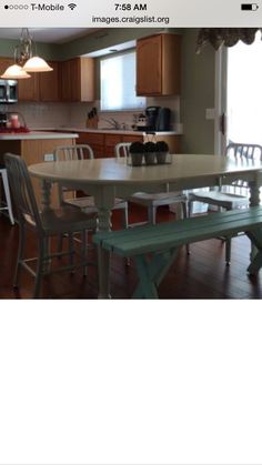 an image of a dining room table and chairs in front of a kitchen with wooden cabinets