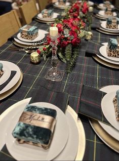 the table is set with plates and place settings for an elegant holiday dinner or special occasion