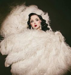 a woman in white fur coat posing for the camera