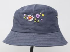 Item: flower embroidered bucket hat Material: 35% cotton, 65% polyester Size: one size fits most, brim measuring 2 inches long Embroidery: hand made with acrylic thread Free first class shipping, upgradable priority mail service. 30 days return policy, feel confident at your purchase! Casual Embroidered Sun Hat With Curved Brim, Summer Cotton Embroidered Hats, Casual Cotton Sun Hat With Embroidery, Handmade Cotton Hats For Outdoor, Handmade Cotton Outdoor Hats, Casual Handmade Cotton Sun Hat, Handmade Cotton Sun Hat Cap, Summer Cotton Hat With Embroidery, Casual Embroidered Bucket Hat For Beach