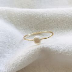 This handmade pearl ring is the perfect accessory for everyday wear, stacking with other rings, or adding a little something to a formal outfit! Details: -made with tarnish free wire and a freshwater pearl -multiple size options  -lightweight and comfortable  **Shipping** Your order will be shipped out the day after you submit your purchase. Minimalist Adjustable Pearl Ring With Charm, Minimalist Pearl Drop Ring For Gift, Minimalist Pearl Drop Ring, Minimalist Everyday Pearl Ring With Charm, Delicate Round Pearl Ring For Everyday, Delicate Everyday Round Pearl Ring, Dainty Hypoallergenic Pearl Ring For Everyday, Stackable Round Pearl Ring, Dainty Everyday Hypoallergenic Pearl Ring