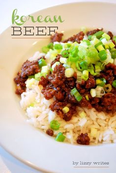 a white plate topped with rice and meat