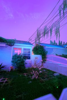 an image of a house that is lit up in the night time with neon lights