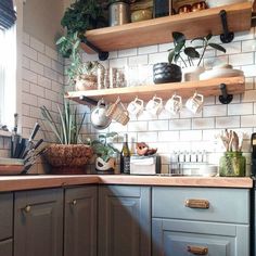 a kitchen filled with lots of wooden shelves