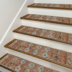 a carpeted stair case on the side of a staircase