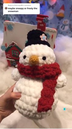 someone is holding up a crocheted snowman