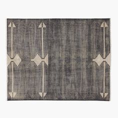 an area rug with arrows on it in grey and beige colors, against a white background