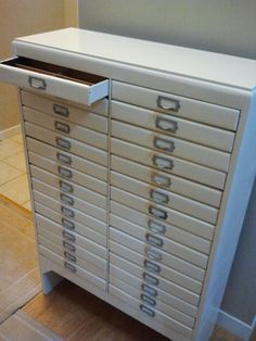 a white cabinet with many drawers on it