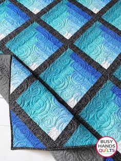 Gaze upon the Waterfall quilt pattern created by Myra Barnes of Busy Hands Quilts! The modern pattern is available in two sizes: Throw and Queen. This yardage-friendly design uses seven fabrics. With the Waterfall II pattern, you can create your unique ombre effect that looks stunning in any farmhouse home! It's a lovely baby gift idea for a loved one.