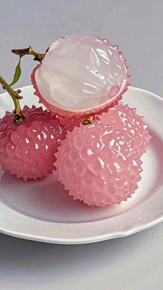 two pink vases sitting on top of a white plate