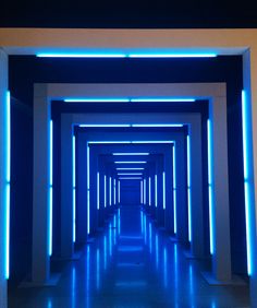 an empty hallway with blue lights in it