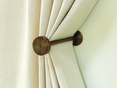 the curtain is pulled back by a pull rod with a round handle on it's side