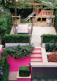 an outdoor garden with various types of plants and flowers in the planter boxes on the side