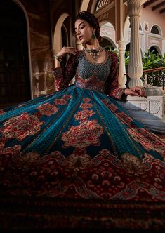 Editor's Note Traditional Indian look in all its regal splendour in our Persian carpet inspired anarkali set with intricate hand embroidery on the yoke and the skirt with beads and sequins. It is styled with a co-ordinated dupatta. Fabric: Viscose silk, net Color: Teal blue Components: Anarkali and dupatta Occasion: Wedding Guest Disclaimer: Product color may slightly vary due to photographic lighting sources or your monitor setting. Care: Dry Clean Only About the Designer Kalista is a luxury fa Lehenga Anarkali, Anarkali With Dupatta, Blue Anarkali, Embroidered Beads, Blouse Yoke, Indian Look, Embroidered Dupatta, Indian Embroidery, Silk Dupatta