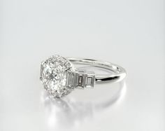 an oval cut diamond ring with baguettes on the side